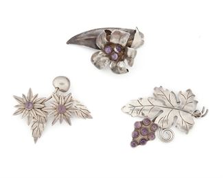 267
A Group Of Fred Davis Silver And Amethyst Brooches
Pre-1948; Mexico City, Mexico
Stamped: FD [Fred Davis]: Further stamped: Silver / Mexico
A group of flower brooches of various motifs, 3 pieces
Largest: 2.25" x 3.1/2"
96.0 grams
Estimate: $800 - $1,200