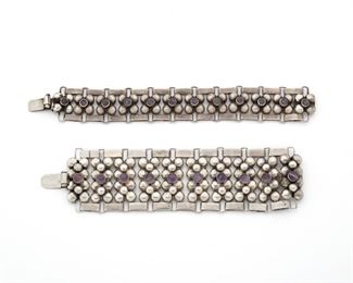 270
Two Fred Davis Silver And Amethyst Bracelets
Pre-1948; Mexico City, Mexico
Stamped: FD [Fred Davis]; Further stamped: Silver / Mexico
The wide link bracelets comprising of rectangular clusters of silver half spheres each centering a round cabochon amethyst, 2 pieces
6.5' L x 2.875" W; 7.5' L x 1' W
169.5 grams
Estimate: $800 - $1,200