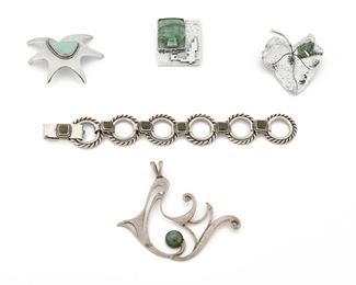 271
A Group Of Carmen Beckmann Jewelry
Third-quarter 20th Century; San Miguel de Allende, Mexico
Stamped: Beckman / Sterling / Mexico
Comprising a double circular link bracelet set with green turquoise, a large free-form pendant set with turquoise, an anemone brooch set with turquoise, a square brooch set with carved jade, and a leaf brooch topped with a carved malachite frog, 5 pieces
Bracelet: 8" L x 1" H; Pendant 3.25" W x 3.25" H; Largest brooch: 2.50" W x 2" H
161.8 grams
Estimate: $500 - $700