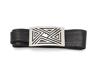 284
An Antonio Pineda Silver Crown Belt Buckle
1953-1979; Taxco, Mexico
Crown mark for Antonio Pineda; Further stamped: Eagle 17 / Hecho en Mexico / Silver / 970 / PZ144
A rectangular belt buckle of a geometric motif centering a crown design on a black leather belt
Buckle: 3.95" L x 2.20" W; Leather: 31" L
151.5 grams
Estimate: $300 - $500