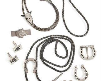 286
A Group Of Antonio Pineda Silver Western-Motif Accessories
1953-1979; Taxco, Mexico
Crown mark for Antonio Pineda; Further stamped: Eagle 3 / Eagle 17; Each variously stamped: Mota Tasco / 925 / 970 / Hecho en Mexico
Comprising a horseshoe bolo tie (1.5" H x 1.25" W), a bull skull bolo tie (1.75" H x 1.25" W), a horseshoe buckle (1.5" H x 1.5" W), a pair of bull's head cufflinks (.75" H x .875" W), two horseshoe accessories bolo pendant and clip (each: 1.5" H x 1.25" W), and a horse head money clip (1" H x 2" W), 8 pieces
162.5 grams gross
Estimate: $800 - $1,200