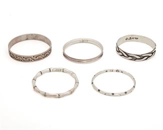 288
Five Antonio Pineda Silver Bangle Bracelets
1948-1953 and 1953-1979; Taxco, Mexico
Crown mark for Antonio Pineda; Stamped: Silver by Tono / Eagle 17; Each variously stamped: Hecho en Mexico / Silver / 970 / Sterling / Taxco 925 Sterling ILD / Mexico
Comprising five bangle bracelets of various designs, 5 pieces
Largest: 8.75" C x .5" H; Smallest: 8" C x .25" H
151.0 grams
Estimate: $500 - $700