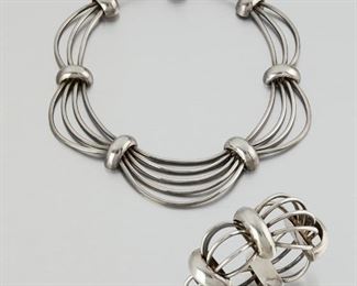 291
A Set Of Antonio Pineda Silver "Birdcage" Jewelry
1953-1979; Taxco, Mexico
Crown mark for Antonio Pineda; Each further stamped: Eagle 17 / 970 / Sterling / Silver / Mexico / ZZ679 / Hecho en Mexico
Each designed in a scalloped, stylized birdcage motif, comprising a necklace (15.5" L x 1.5" H) and bracelet (6.5" L x 1.5" H), 2 pieces
270.0 grams
Estimate: $1,000 - $1,500