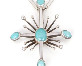 292
An Antonio Pineda Silver And Blue Glass Pendant Necklace
1953-1979; Taxco, Mexico
Crown mark for Antonio Pineda; Further stamped: [indistict eagle mark] / Eagle 58; Each variously stamped: Hecho en Mexico / 970 / JVL Taxco
Comprising a stylized maltese cross with five oval blue glass stones suspended by a cylindrical bar detachable neck chain, 2 pieces
21.5" L x 2.5" H x 2" W
46.0 grams
Estimate: $500 - $700