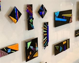 Elegant Elongated Dichroic Fused Glass Mixed Media in Custom Black Frame. This is a truly stunning piece of art! Each piece fused glass was custom created by Minneapolis Artist, Denise Prince.  The colors on these amazing hand crafted tiles change as you move along the hallway and the appearance changes as the light patterns change in the room throughout the day. 

Measures; 81" L x 4' H 

Features an acrylic front and was professionally framed.