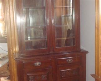 Dining Room: An antique step-back hutch has two upper doors that reveal four shelves (three are adjustable). The lower section has two drawers and two doors--lots of storage!  The key will be with the cashier.