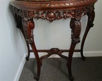 Carved demilune table with marble top