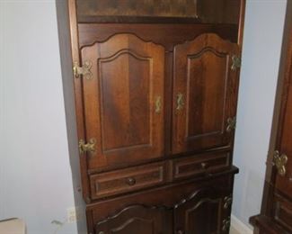 THESE CABINETS ARE OAK AND PURCHASED IN BELGIUM WHEN THE OWNERS LIVED OVERSEAS.   VERY HANDSOME.