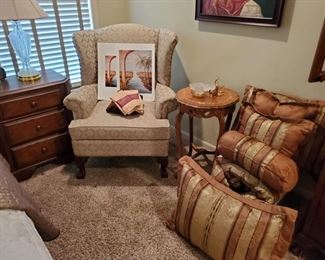 Cream Wing Chair, Inlaid Table, Queen Bedding.