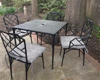 Four-piece wrought iron set with cushions.