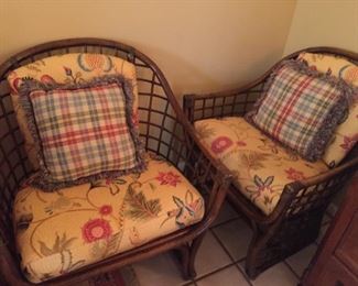 Matching rattan chair with cushions and pillows.