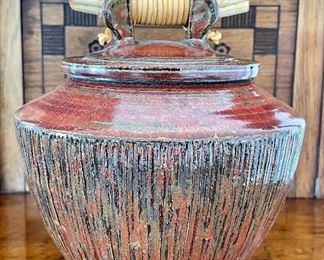 Item 35:  David Yungner, (American, 1956-2013), covered bowl, glazed art pottery with leather-bound wood handle - 7": $85
