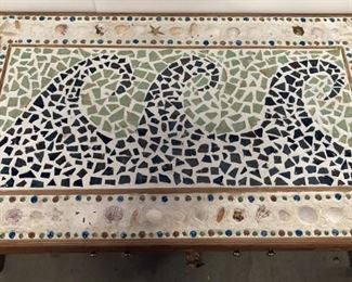 coffee table with mosaic beach wave seashell scene on top