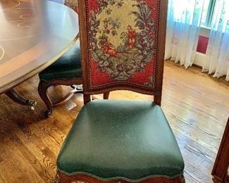 $395 each - Set of 12 "tapestry", hobnailed, green leather seat chairs. Each 52" H, 24" W, 23" D, seat height 18". TABLE  AND CHAIRS MUST STAY IN THE HOME UNTIL THE HOUSE IS SOLD!
