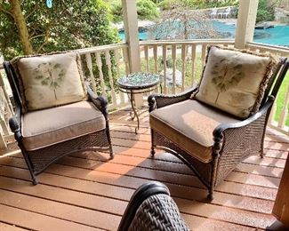 $450 pair - Pair of resin wicker/cast aluminum arm chairs - 35"H; 29"W: 34"D with palm tree pillows (each 24" x 20.5") 