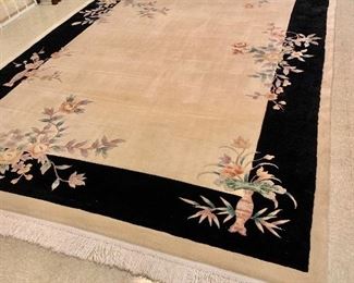 $750 - Chinese floral rug with black border and fringe 158"L; 102"W