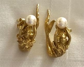 Detail of mermaid holding pearl 18K earrings 
