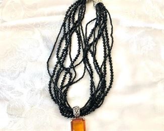 $28 Black multi strand beaded necklace with amber glass drop.  20"L