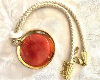 $16 Orange pendant on woven cord Chico's.   22"L.   Pendant: 3"L