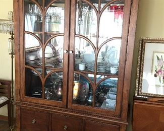 Farmhouse dining room China cabinet with touch lighting and a hidden sliding rear doors.