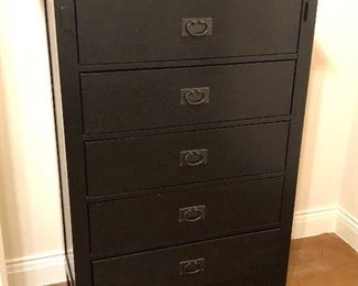 Wooden tall chest with a black finish and metal hardware 