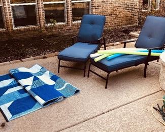 Outdoor patio lounge chairs with cushions, pool noodles, vibrant blue outdoor rug 