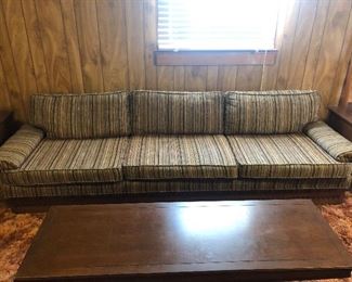amazing vintage sofa, super long and in excellent condition and sitting on original shag carpet