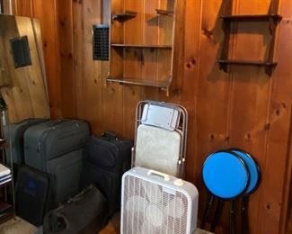 Assorted luggage, fans, wall shelves