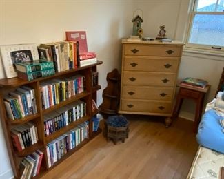 Large book collection, tall dresser, side tables, wall shelves and footstools