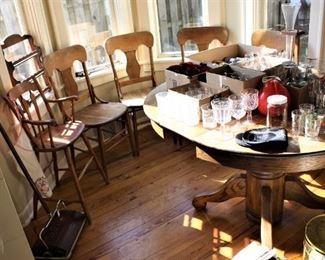 Oak pedestal table with leaves and 4 chairs, antique high chair and assorted glass sets, antique Bissell floor sweeper