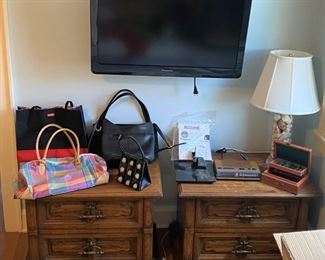 Two nightstands, flat screen television, handbags
