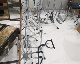 LOTS OF MUSICAL INSTRUMENT STANDS.