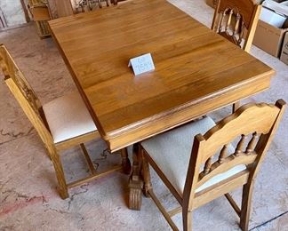 Lot 7594. $350.00. Beautiful Antique Table and Chairs. This table is small but includes two leaves. The base is incredible and the chairs are sweet.  This table was in the homeowners family since it was made, it is stamped 2/23/1934. Was at one time white and the homeowners had it stripped to its original wood. STUNNING. Table measures: 45"l x 32"w x 30"h with two 9" leaves.  4 chairs: 16"w x 36" to back x 16.5"deep and 13"h to seat.  