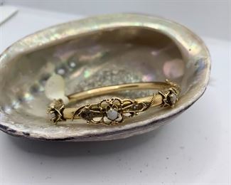 Item #30 view 2  Vintage 14 K Gold Bangle with 3 opals. It measures 2.5" by 2.5" with about an 8 inch circumference. $500