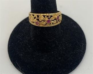 18 K 2.8 g ring with 3 pink stones( possibly sapphires) $120
