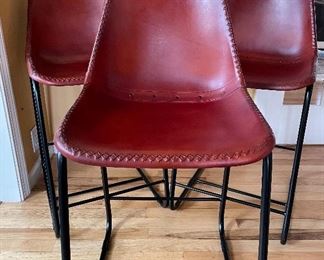 3 red leather molded stools