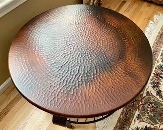 Round metal table. iron base w/ hammered top
