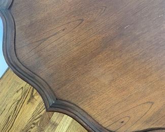 Scalloped edge round pedestal table measures 30" in diameter and 28.5" high