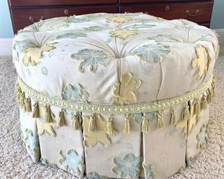 Floral tufted ottoman on casters measures 37" in diameter.