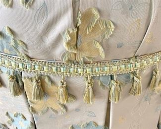 Floral tufted ottoman on casters measures 37" in diameter.