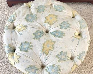 Floral tufted ottoman on casters measures 37" in diameter.