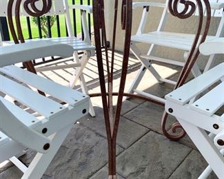 Iron base glass top table measures 48" in diameter. White chairs are SOLD.
