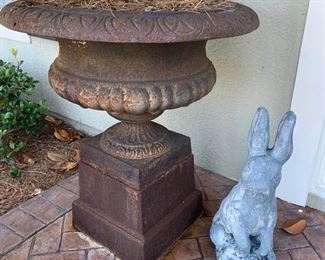PAIR OF URNS AVAILABLE                                              Antique cast iron urns atop a pedestal base. Each urn measures 21" x 29". Each pedestal measures 12" high bringing the overall height to 33"