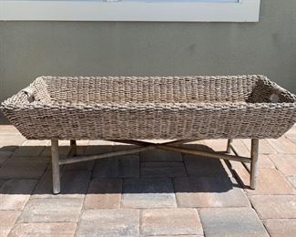 Wicker trough coffee table measures 48" x 20" x 17" Wicker trough sits on top of wood base as shown in photos.