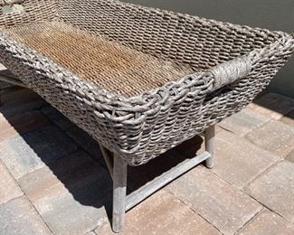 Wicker trough coffee table measures 48" x 20" x 17" Wicker trough sits on top of wood base as shown in photos.