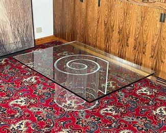 ACRYLIC & GLASS LOW TABLE | having a heavy 1" glass top resting on a spiral acrylic base; h. 16 x 48 x 35 in.; no apparent signature 