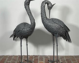 PAIR SCULPTED TIN STORKS | one preening, the other looking forward; h. 31 in. 