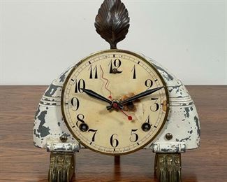 "KOWALSKI CLOCKWORKS" DESK CLOCK | wild distressed retro clock with paw feet and a rear scroll foot, leaf finial; with Kowalksi impressed badge and signed "Sue Kowalski 10/96"; 9 x 9 x 6-1/2 in. 