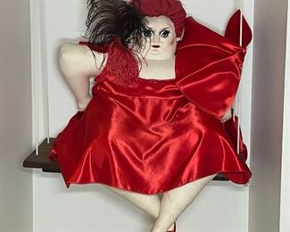 OPERA SINGER STUFFED FIGURE | in a red satin dress suspended from a swing; h. 26 in. (seated) swing width 22 in. 