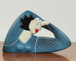 PAINTED CERAMIC FEMALE FIGURE | showing a woman resting her head on her hand, signed "Cole"; h. 6 x 10 in. 